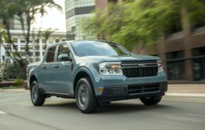 A blue Ford Maverick Hybrid XLT parked on a scenic outdoor setting, showcasing its sleek design and modern features.