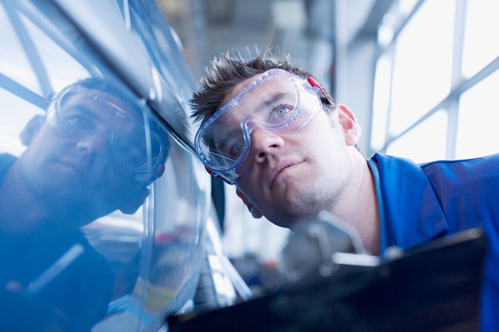 Technician is inspecting a car